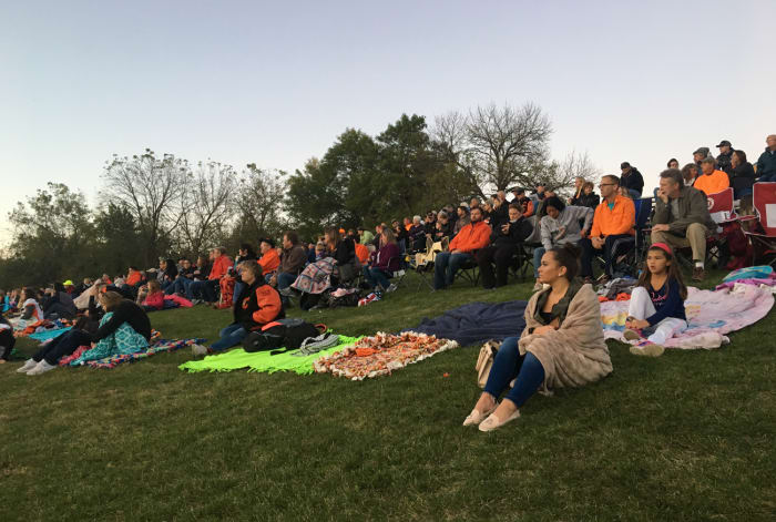 Fans sit on the hillside at the Clippers game.